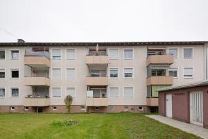an apartment building with balconies and a yard at Business Apartment in Oberkochen in Oberkochen