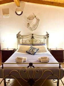 a bedroom with a bed with two towels on it at Villa Sofia Casa Vacanze in Marconia