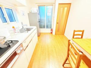 a kitchen with a sink and a refrigerator at 池袋本町101 in Tokyo