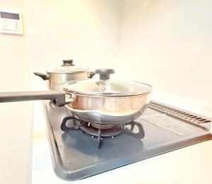 two pots sitting on top of a stove at 池袋本町101 in Tokyo
