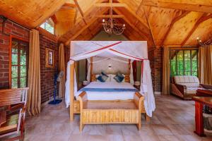a bedroom with a canopy bed in a wooden house at Under The Shade Safari Lodge in Arusha +42 photos