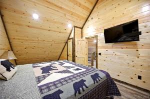 a bedroom with a bed in a log cabin at Bear with Me Cabin in Broken Bow in Broken Bow