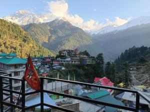 a view from a balcony of a town with mountains at Vigyan Guest House Tosh in Tosh