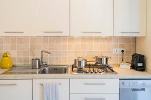 a kitchen counter with two pots and a sink at Seaview Apartment - B in Riva Trigoso