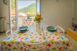 a dining room table with a table cloth with flowers on it at Seaview Apartment - B in Riva Trigoso +21 photos