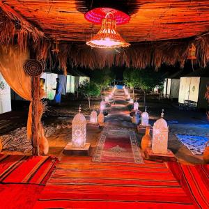 a row of lanterns on the floor of a building at Sunlight Luxury Desert Camp in Merzouga