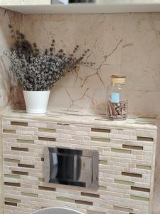 a brick fireplace with a tv on top of it at Casuta cu povesti in Campina