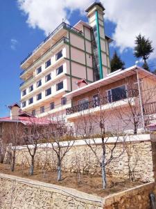 a large building with trees in front of it at Hilltop Resorts By Fidato Lepere in Matiāna +22 photos