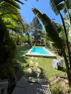 a swimming pool in the middle of a yard at Casaquinta grande con pileta y parrilla in Camba Punta +7 photos