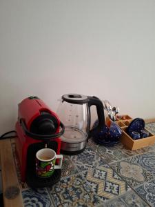 a coffee maker and a cup of coffee on a table at TartaRigo b&b in Bologna
