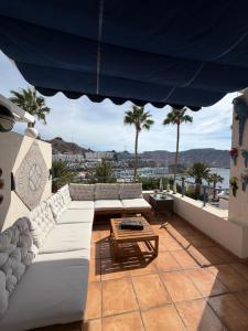 a living room with a couch and a table at Toni LuXx Suite Monte Golf in Mogán