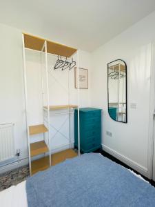 a bedroom with a bed and a blue dresser and a mirror at Double Room in Shared House in Southampton