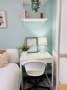 a white desk with a chair next to a bed at Double Room in Shared House in Southampton