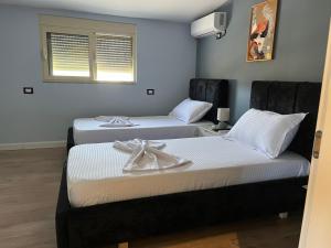 a room with two beds with towels on them at Adriatic View Penthouse in Durrës +6 photos