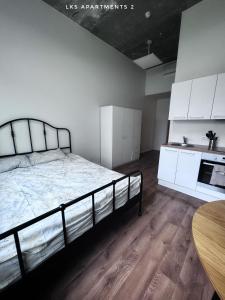 a bedroom with a bed and white cabinets and a table at LKS apartments 2 in Kose