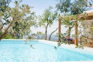 a pool at a resort with trees in the background at Quinta Fonte Grande in Santiago do Cacém