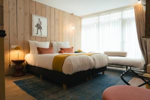 a bedroom with a large bed and a window at Max Brown Hotel Canal District, part of Sircle Collection in Amsterdam