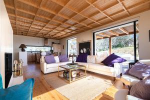a living room with two couches and a table at Quinta Fonte Grande in Santiago do Cacém