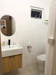 a bathroom with a sink and a toilet and a mirror at nulacaz in Rose Hill