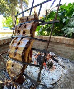 a rack of meat cooking on a grill at Casa quinta en Pilar solo Eventos y Pasar el Día in Pilar