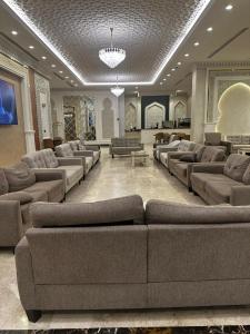 a large living room with couches and chairs in a building at الخلفاء الماسى in Makkah +36 photos