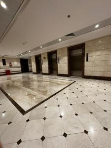 a large room with a tiled floor in a building at الخلفاء الماسى in Makkah