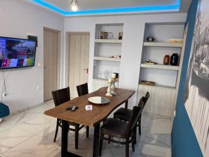 a dining room with a wooden table and chairs at Villa Rafaela in Grevena in Grevena