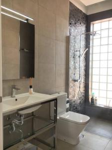 a bathroom with a sink and a toilet and a shower at Villa Sunset View Tenerife, Simply Amazing in Adeje