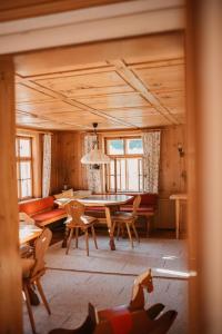 a living room with a table and chairs and a couch at Hus Sigritta in Vandans