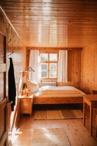 a bedroom with a bed in a wooden room at Hus Sigritta in Vandans +44 photos