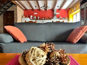 a couch with two pine cones on a table at El Arreñal del Cañón del Río Lobos in Santa María de las Hoyas