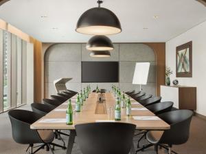 a large conference room with a long table and chairs at Mercure Dubai Gold District in Dubai