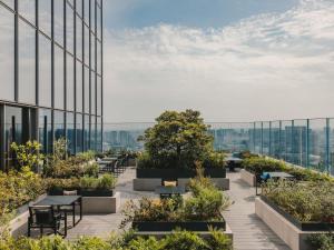 a view from the top of a building with tables and plants at Fairmont Tokyo in Tokyo