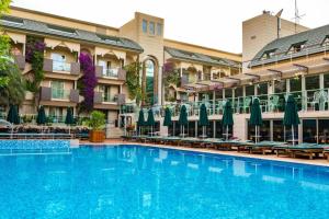 a large swimming pool in front of a hotel at AMBAS PLAZA Hotel -All Inclusive Plus in Antalya