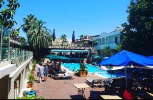 a group of people standing around a swimming pool at AMBAS PLAZA Hotel -All Inclusive Plus in Antalya