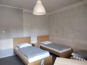 a room with two beds and a table at Agroturystyka Pod Orzechem in Lubiąż