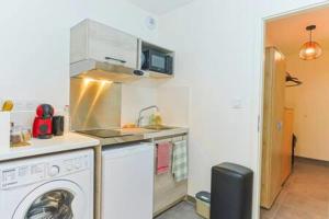 a kitchen with a washing machine and a washer at Le Venise I Private Parking I Spacious & Bright in Colmar