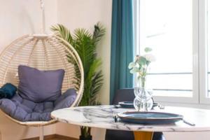 a room with a rattan chair and a table at Le Venise I Private Parking I Spacious & Bright in Colmar