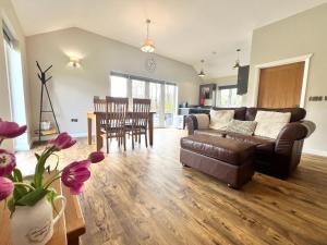 a living room with a couch and a table at Dwrgi in Llanybyther +29 photos