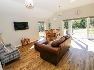 a living room with a couch and a table at Dwrgi in Llanybyther