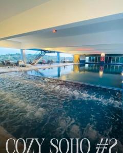 a swimming pool in the middle of a building at Cozy Soho #2 By TwoKeys in Miri