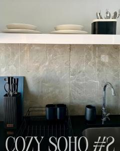 a kitchen with a sink and a counter with dishes at Cozy Soho #2 By TwoKeys in Miri