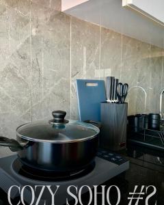 a pot on top of a stove in a kitchen at Cozy Soho #2 By TwoKeys in Miri +12 photos