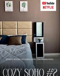 a bedroom with a bed and a mirror and a tv at Cozy Soho #2 By TwoKeys in Miri