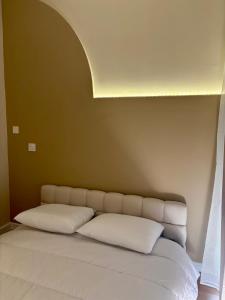 a bed with two white pillows in a room at Casa Bert - Appartement pour 2 personnes - Moderne - Balcon in Brive-la-Gaillarde