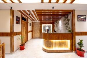 a lobby with a bar with plants in it at Monal Homestay in Kulu