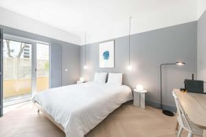 Postel nebo postele na pokoji v ubytování Jardim Suites by Olala Homes + 16 fotografií