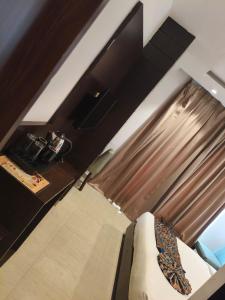 a living room with a couch and a window at AMRITSAR AVI INN 100 Meter from golden temple in Amritsar