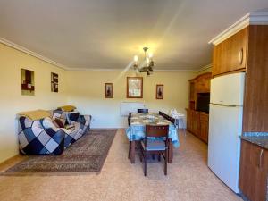 a living room with a couch and a table at Casa rural Herminia in Ourense