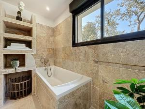 a bathroom with a sink and a window at Chambre Deluxe - vue jardin - située dans le triangle d'or du Luberon in Ménerbes +20 photos